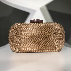 Detailed view of the gold woven evening clutch bag, showing exquisite texture and clasp.
