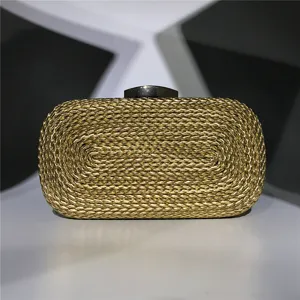 Gold metallic woven clutch bag detail shot, elegant evening handbag texture and clasp view.