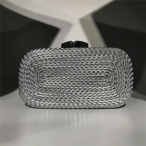 Silver metallic woven evening clutch detail shot, showing exquisite craftsmanship and texture.