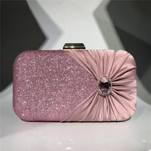 Pink glitter and satin evening clutch bag with sparkling rhinestone clasp for women party wear.