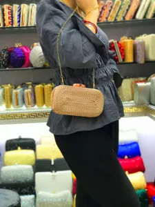 Woven box clutch bag with gold chain strap, elegant evening party shoulder handbag for women details.