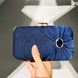 Elegant navy blue glitter and pleated satin clutch bag with dazzling crystal brooch for women.