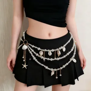 Detailed view of beach style multi-layer pearl waist chain with seashell and starfish charms.