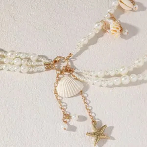 Beach pearl seashell waist chain detail, golden body chain with starfish pendant accessories.