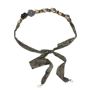 Woven fabric chain belt for women, featuring chic floral embellishments and metal accents.