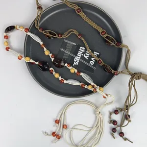 Bohemian beaded waist chain detail showcasing colorful wooden and clear beads on cord.