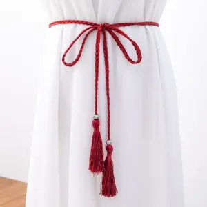 Red braided tassel belt, bohemian waist rope for women, vintage ethnic accessory detail.