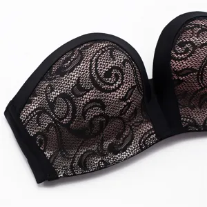 Strapless push-up bra with delicate black lace overlay and nude lining for wedding.