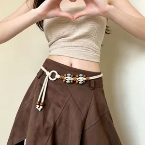 Boho woven waist chain detail, beige rope belt with wooden beads and turquoise accents.