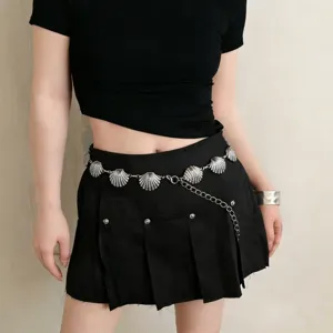 Silver shell waist chain detail close-up, vintage boho metal belt accessory for women.