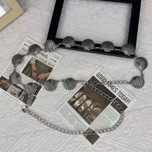 Vintage bohemian metal shell waist chain for women, retro silver tone body belt fashion jewelry.