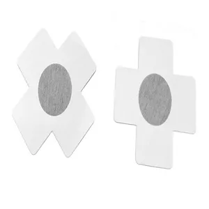 Close-up detail of disposable cross-shaped adhesive nipple covers, soft and breathable fabric.