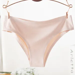 Detailed view of seamless women solid color brief hanging on rose gold metal hanger.