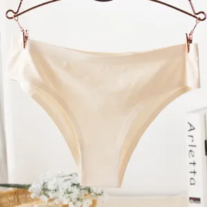 Close-up detail of champagne seamless women ice silk panties hanging on hanger nicely.