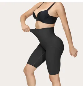 Detail view of women's black high waist tummy control shaping shorts, showcasing elasticity.