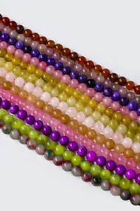 Detailed close-up view of colorful natural stone round loose beads, perfect for DIY jewelry making.