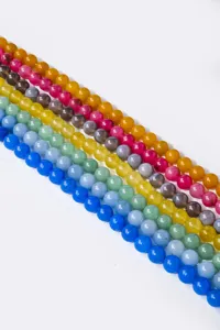 Close-up of colorful gemstone agate round beads semi-finished strands for DIY jewelry making.