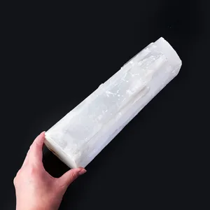 Close-up detail of natural white selenite rough crystal wand for desktop DIY decor.