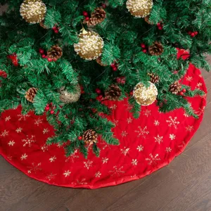 Detailed close-up view of the plush red Christmas tree skirt featuring sparkling gold sequin snowflakes.