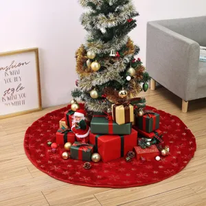 Red plush Christmas tree skirt with golden sequin snowflakes, festive holiday party decor detail.