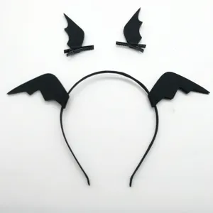 Close-up detail of black bat wing hair clips and headband, Halloween costume accessory.