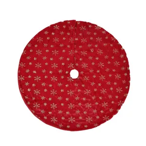 Red plush Christmas tree skirt featuring gold glitter snowflakes for holiday party decor.
