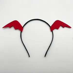 Close-up of black headband with red bat wings detail, Halloween costume accessory.