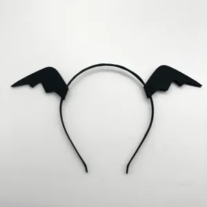 Close-up detail of the black bat wing headband, showing fine fabric texture and neat stitching.