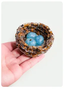 Handmade resin bird nest ornament with blue crystal stone eggs for home decor and gifts.