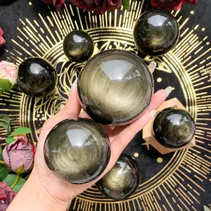 Natural golden obsidian sphere crystal ball for home office feng shui decor and display.