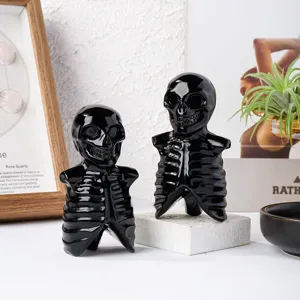 Black obsidian skull skeleton crystal carving figurine for Halloween home desktop decoration.