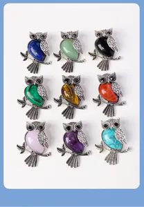 Detailed view of vintage silver owl pendants with colorful natural stone inlay for necklace jewelry.