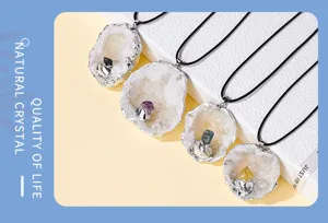 Closeup view of natural crystal geode pendant necklace with silver-plated edge detail.