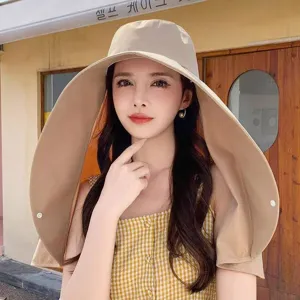 Detailed view of the wide brim khaki sun hat worn by model, perfect for outdoor summer UV protection.