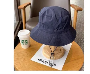 Detail view of the waterproof bucket hat with windproof drawstring for outdoor summer hiking.