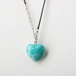 Natural amazonite heart stone pendant necklace with black cord and chain detail close up view.