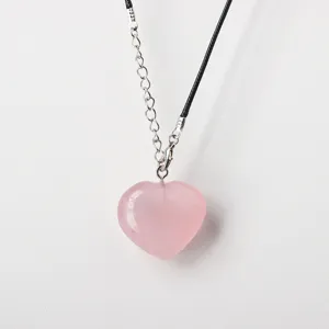 Natural pink quartz heart pendant necklace with black cord and silver extension chain for women.