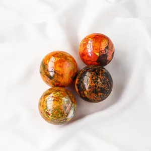 Detailed close-up view of polished natural crystal stone spheres with vibrant patterns.