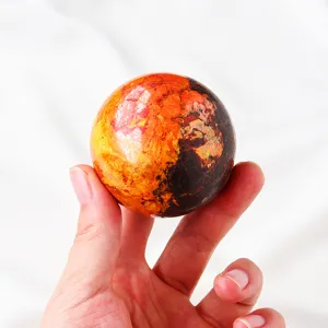 Natural golden stone crystal sphere detail view, vibrant multi-color mineral gemstone ball decor.