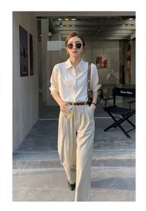 Detailed outdoor scene showcasing a stylish thin leather belt paired with casual trousers.