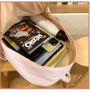 Pink casual campus backpack interior detail showing large storage capacity for daily use.