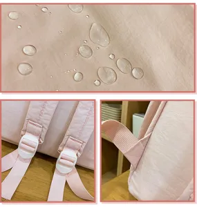 Pink casual school backpack detail view showing waterproof fabric and adjustable straps.
