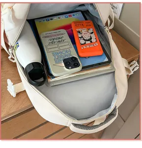 Large capacity beige canvas backpack for students and travel, spacious laptop compartment.