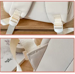 Beige backpack detail shot showing durable shoulder straps, plastic adjusters and stitching.