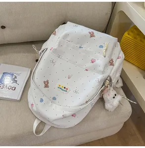 Cute bear print backpack detail view showing soft white fabric, polka dots and front pocket.
