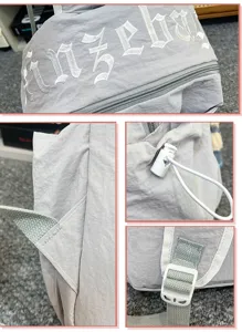 Detailed view of the casual nylon backpack showing adjustable straps, buckles and embroidery.