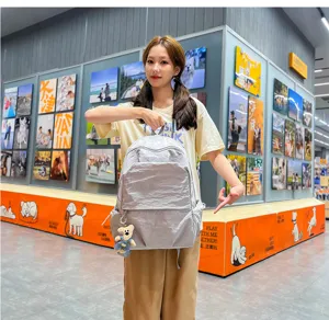 Korean style casual commuter nylon backpack with cute bear pendant, large capacity daily bag.