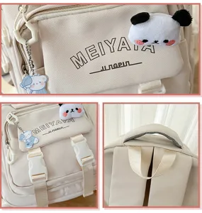 Detail view of beige canvas backpack with cute plush pendant and secure buckle straps.