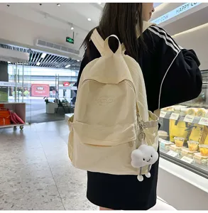 Detailed view of casual canvas backpack with cute cloud pendant, perfect for daily campus use.