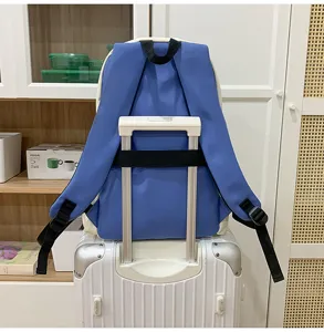 Stylish blue and white student backpack with luggage strap, perfect for daily casual commuting.